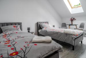 a bedroom with two beds and a table with chairs at Gościniec Sarnówka  +53 photos