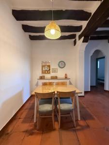 a dining room with a wooden table and chairs at La Casuca in Riaza
