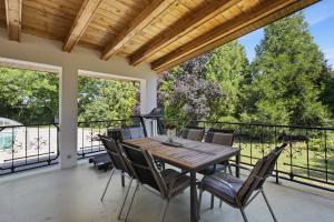 a dining room with a table and chairs on a balcony at Vila v Lahošti in Teplice