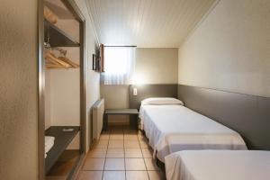 a small room with two beds and a window at El Corral in Lladurs +56 photos