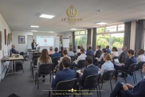 a group of people sitting in chairs in a room at Hôtel Le Rohan Charme et Caractère in Pontivy