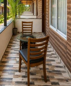 a table and chairs on the porch of a house at Coco Nest Mandrem in Mandrem