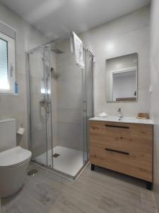 a bathroom with a shower and a toilet and a sink at Corvera Guss in Corvera +47 photos