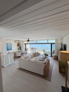 a living room with a couch and a living room with a view at Mermaid Escape - Amazing Views! in East End +49 photos