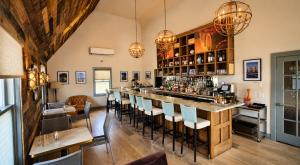 a bar in a room with chairs and tables at Pilgrim House in Provincetown