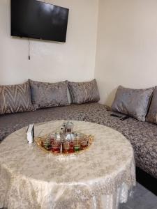 a living room with a table and a couch at Maison Traditionnelle in Casablanca