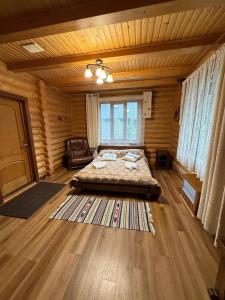 a bedroom with a bed in a wooden room at Дикий Кіт in Vorokhta