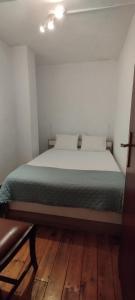 a bedroom with a large bed with white sheets and pillows at Casa Rústica da Lavandeira in Valongo dos Azeites +20 photos
