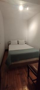 a large bed in a room with a wooden floor at Casa Rústica da Lavandeira in Valongo dos Azeites