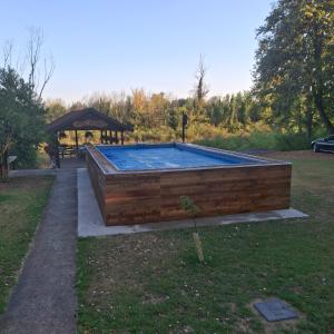 a swimming pool in a yard with a gazebo at Drinska Ljepotica in Bijeljina