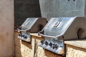 two metal plates on a counter in a bathroom at Kihei Beach 606 - Direct Ocean Front, Central AC! in Kihei