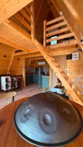 a room with a wooden ceiling and a staircase at Nota A Frame in Šakotinac
