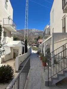 a walkway between two buildings in a city at MostOliva luxury Rooms in Pržno