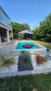 a swimming pool with a statue next to a house at "L'appart Idéal" in Deyme