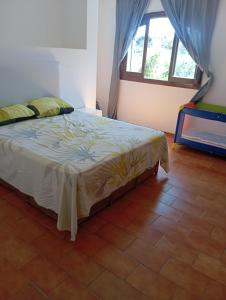 a bedroom with a bed in a room with a window at Villa pieds dans l'eau Cabo in Cabo Negro