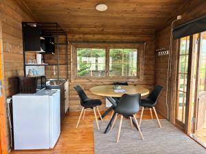 a kitchen and dining room with a table and chairs at Hotel Stadarborg in Breiðdalsvík