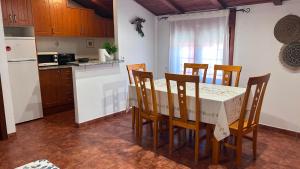 a kitchen with a table and chairs and a refrigerator at Apartamento Tres in Guadalaviar