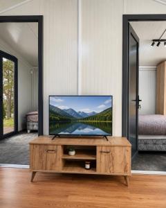 a living room with a flat screen tv on a table at Oaza mira Zlatibor, Tornik - ENTIRE HOME at Ski Centar Tornik in Tornik