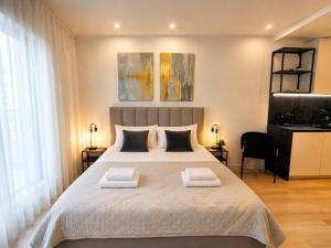 a bedroom with a large bed with two towels on it at Poznań Plac Wolności 6 Bond in Poznań