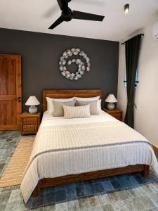a bedroom with a large bed and a ceiling fan at Sea Esta in Le Morne +31 photos
