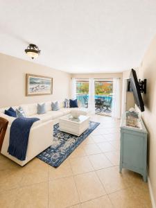 a living room with a couch and a table at Beach Palms- Unit 102 in Clearwater Beach