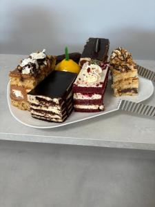 four different types of cakes on a plate at Mn Hotel Borjomi in Borjomi