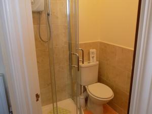 a bathroom with a toilet and a glass shower at Belle View in Skegness