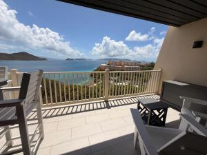 a balcony with chairs and a view of the ocean at Mermaid Escape - Amazing Views! in East End