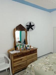 a bedroom with a dresser and a mirror at 25 Spice in Port Antonio