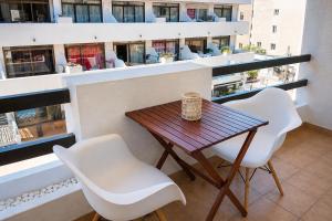 a table and chairs on the balcony of a building at Formentera Suite 3 in Es Pujols
