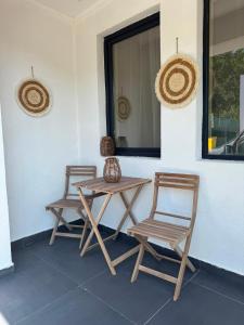 two chairs and a table on a patio at Casuta Vacanta Sadu in Cisnădie