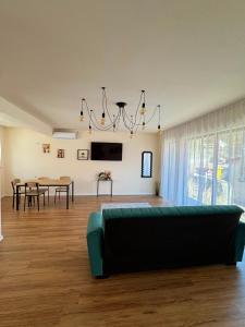 a living room with a couch and a table at Casuta Vacanta Sadu in Cisnădie