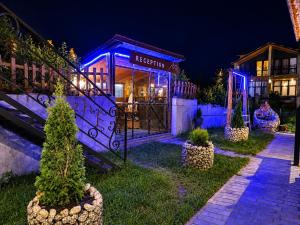 a house with blue lights on it at night at Vache Hotel in Kazbegi