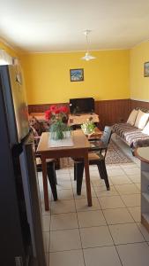 a living room with a table and a couch at Cabaña Don Claudio in Osorno