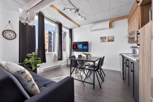 a living room with a couch and a table at Lofts Orizon in Rimouski