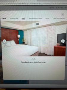 a television screen showing a bedroom with a bed at Residence Inn in Maumee