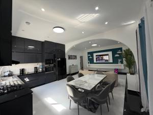 a kitchen and living room with a table and chairs at C-Appart Residence in Tuléar