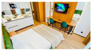 a bedroom with a bed and a bathroom with a tv at VIP In Alliance Palace in Batumi