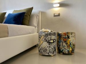 two suitcases sitting on a floor next to a bed at Signature Design & Panoramic Views in Montecatini Terme