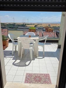a white table and chairs on a patio with a view at Casa Mary in Lavello