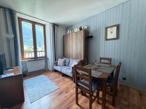a living room with a table and a couch at Abeille de Chamonix in Chamonix