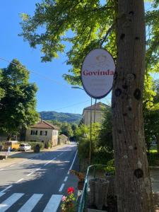 a sign on a tree next to a street at Govinda in Pontinvrea +2 photos