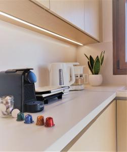 a kitchen counter with a coffee maker on a counter top at Blue Coast - Seaside Apartment in Keratokampos +9 photos