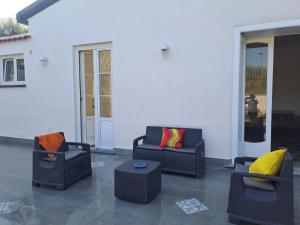 a patio with two couches and a table at Relais Soleil in Vico Equense