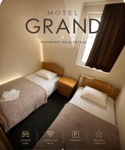 two beds in a room with a sign that reads model grand at Motel Grand in Rožaje
