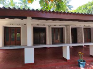 a building with a row of doors at Amma's Homestay in Jaffna