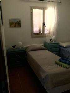 a bedroom with two beds and a window at Botrus Divin Casa in Brindisi