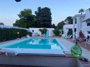 a swimming pool in front of a house at Botrus Divin Casa in Brindisi +6 photos