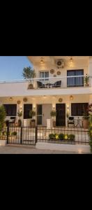 a large white building with a fence in front of it at Sea Apartments in Larnaca
