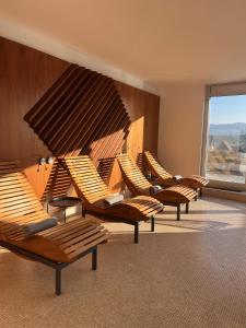 a row of chairs in a room with a large window at Antonie Hotel****superior in Frýdlant